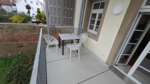 a balcony with a table and chairs on a house at Eppingen Anno 1900 in Eppingen
