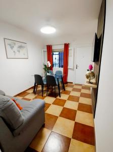 a living room with a couch and a table and chairs at Casa Marbella in Fuengirola