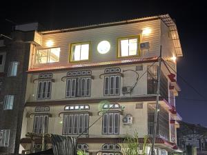 a building with a clock on the top of it at Rooftop Grove Zenith in Guwahati