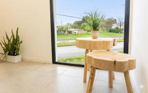 a table and stool in a room with a window at RM Campana Hotel in Campana