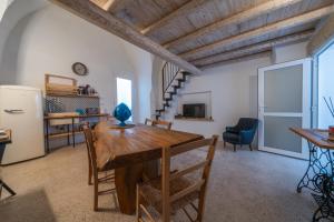 a kitchen and dining room with a table and a refrigerator at Amazing Apartment Alla Corte with pool and sauna in Taurisano +47 photos