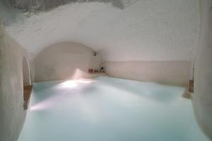 a room with a white floor and a white ceiling at Amazing Apartment Alla Corte with pool and sauna in Taurisano