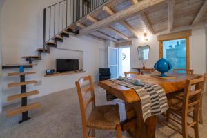 a dining room with a wooden table and a staircase at Amazing Apartment Alla Corte with pool and sauna in Taurisano