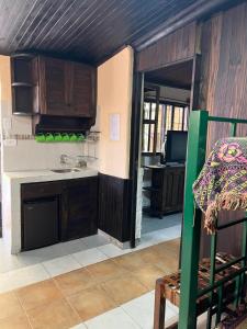 a kitchen with wooden cabinets and a sink at El Refugio in Yala