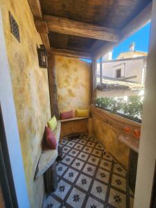 a room with a balcony with a tiled floor at The Poets' Retreat in Sulmona +38 photos