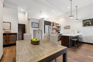 a kitchen with a table with a bowl of fruit on it at 2nd Street Lofts 209 in Whitefish