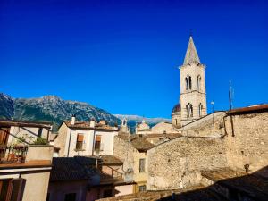 a church with a steeple on top of a city at The Poets' Retreat in Sulmona