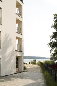 a white building with a view of the ocean at Apartament 22 in Boszkowo-Letnisko