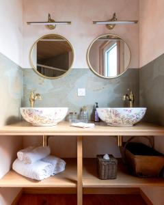 een badkamer met twee wastafels en twee spiegels bij Le Silo du Domaine des Ecus d'Or in Veuvey-sur-Ouche