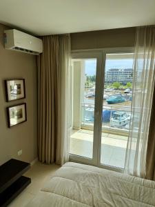 a bedroom with a bed and a large window at CONDOMINIOS DE BAHIA GRANDE NORDELTA!! Tigre in Tigre