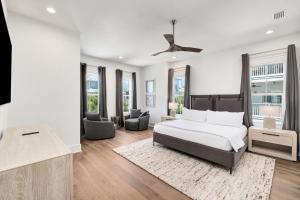 a bedroom with a bed and a living room at Oz by The Sea in Inlet Beach +69 photos