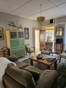 a living room with a couch and a coffee table at Cheerful and spacious 4-bedroom Cottage in Rosmuck