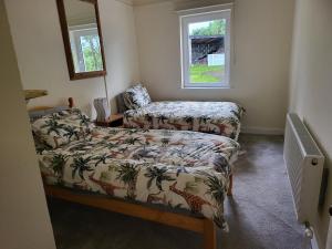 a small bedroom with a bed and a window at Cheerful and spacious 4-bedroom Cottage in Rosmuck