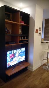 a flat screen tv sitting in a entertainment center at Copa Lido Apartment in Rio de Janeiro