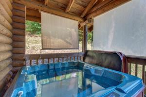a jacuzzi tub in the back of a cabin at Unforgettable Dreams By Avada Properties in Sevierville