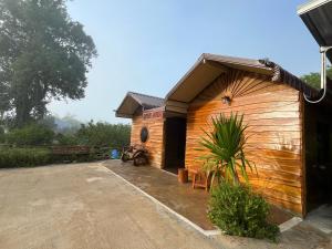a small wooden building with at บ้านสวนพงษ์ศิริ Baan Suan Pongsiri in Chat Trakan