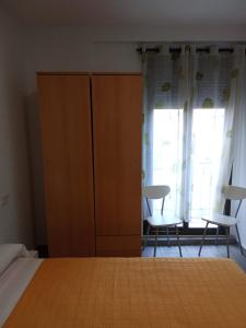 a bedroom with a bed and two chairs and a window at La Ferroviaria -Suite 1 Dormitorio Con Salón más Baño Privado - Balcón - 2º Sin Ascensor- in Zaragoza