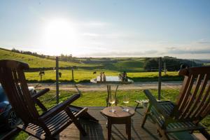 a patio with two chairs and a table and a fountain at Unique Glamping Experience - The Horse Box in Bradstone