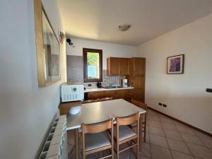 a kitchen with a table and chairs in a room at Lily apartment, Stunning Lake View in Germasino