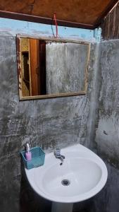 a bathroom with a sink and a mirror at Hometown Pai Boutique Bungalow in Pai