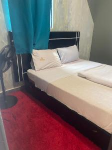 a bedroom with two beds and a red carpet at Javelin Palace Hotel in Kampala +11 photos