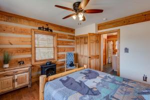 Un dormitorio con una cama y un ventilador de techo. en Cozy Bear Cabin, en Boone