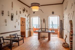 a room with a table and some items on the wall at Maison Crespin in Dakar