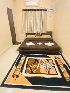 two beds in a room with a rug on the floor at The Den -Villa -1 or 2BHK -Near - Airport -IT park in Chennai