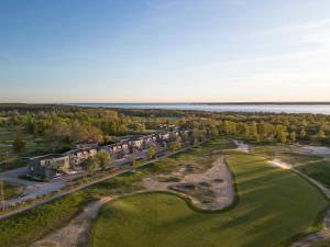 an aerial view of a resort with a golf course and the ocean at Luxury Living at Ekerum Öland Heated Pool, Golf & Sea! in Borgholm