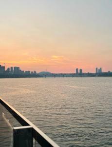 a view of a bridge over the water at sunset at 둔촌트리하우스 Kspo in Seoul