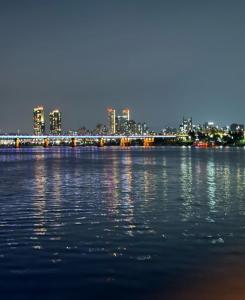 a large body of water with a city in the background at 둔촌트리하우스 Kspo in Seoul