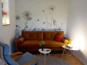 a living room with a couch and two tables at Auszeit-Oase im Waldviertel in Dobersberg