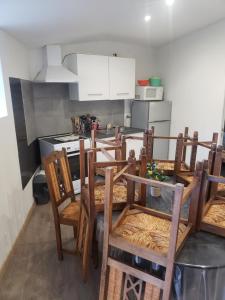 a kitchen with a table and chairs in a room at Charmante maison de campagne in Pont-Trambouze