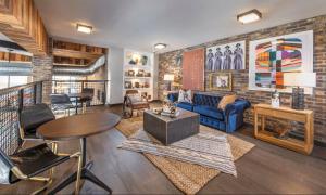 a living room with a brick wall at Landing Apartments - Phoenix Warehouse District in Phoenix