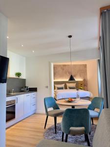 a room with a bed and a table and chairs at Apartmenthaus Blauer Wolf by ROom for LIving Gunzenhausen in Gunzenhausen +37 photos