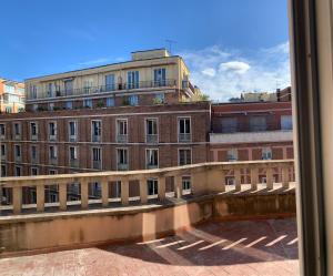 a view of a large brick building from a window at MARCONI 2 rooms in Bologna