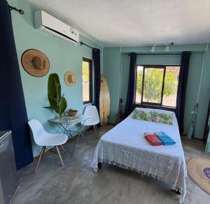 a bedroom with a bed and a table with chairs at 5 Spots Studio in La Gaulette