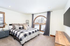 a bedroom with a bed and a large window at Riverside A101 - Riverside Hummingbird in Telluride