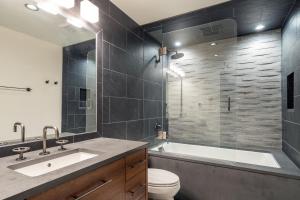 a bathroom with a tub and a toilet and a sink at Riverside A101 - Riverside Hummingbird in Telluride +8 photos