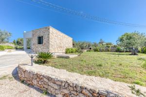 a stone wall in front of a house at Villa Elena in Marina di Pescoluse