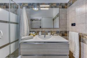 a bathroom with a sink and a mirror at Villa Elena in Marina di Pescoluse