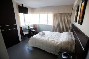 Cama ou camas em um quarto em Mariategui Hotel & Suites