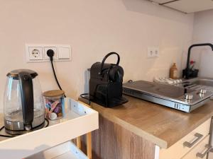 a kitchen with a counter with a toaster and a stove at Prime Location 1BR Apartment Walk Everywhere in Eindhoven