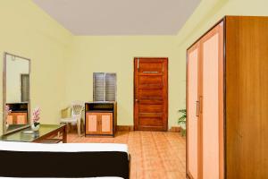 a living room with a couch and a table at Hotel O Delight Rooms in kolkata
