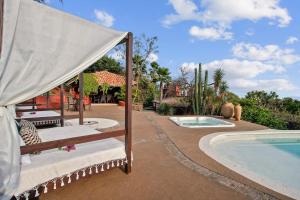 a patio with a bed next to a swimming pool at Private 5-Bedroom Compound with Pool Tepoztlán Retreat in Tepoztlán