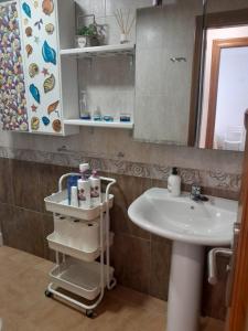 a bathroom with a sink and a mirror at APARTAMENTO EL TIMON in Carboneras