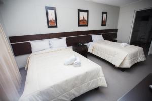 Cama ou camas em um quarto em Mariategui Hotel & Suites