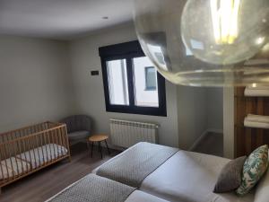 a bedroom with a bed and a window at CREDENCIAL Bulevar in Sarria