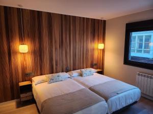 a hotel room with two beds and a window at CREDENCIAL Bulevar in Sarria
