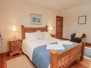 a bedroom with a large bed and a chair at Usherwoods Dairy in Lancaster